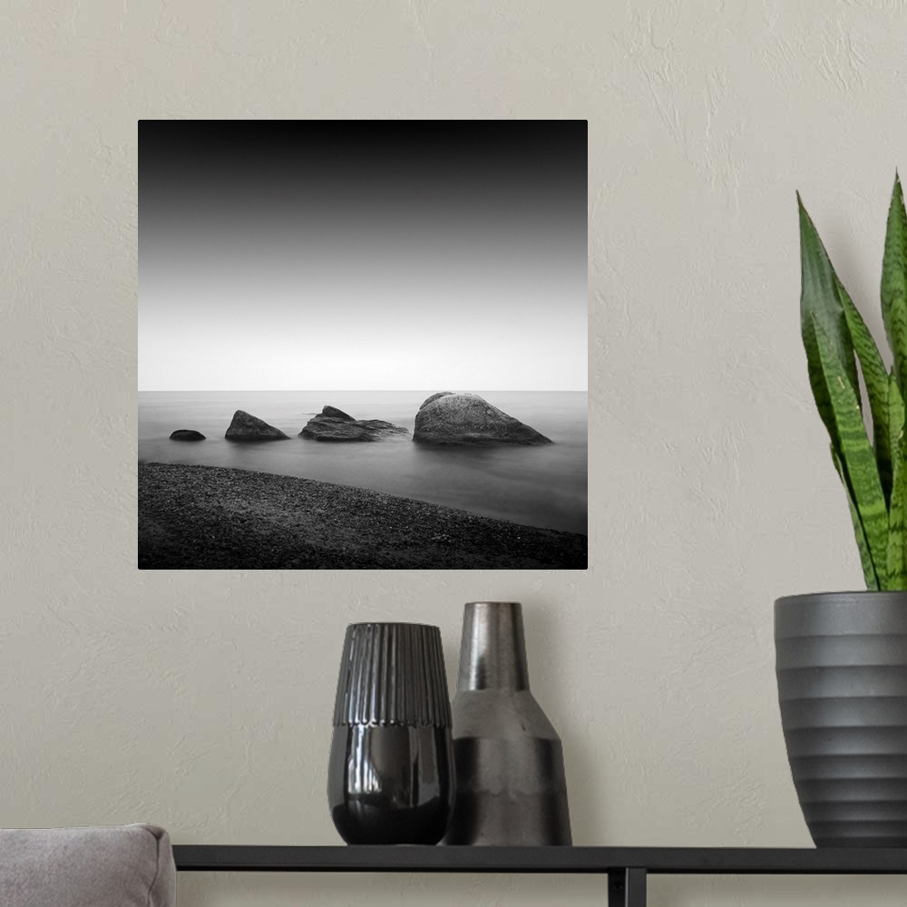 A modern room featuring Daytime long exposure seascape with object in the sea. The photo taken in black and white. Black ...