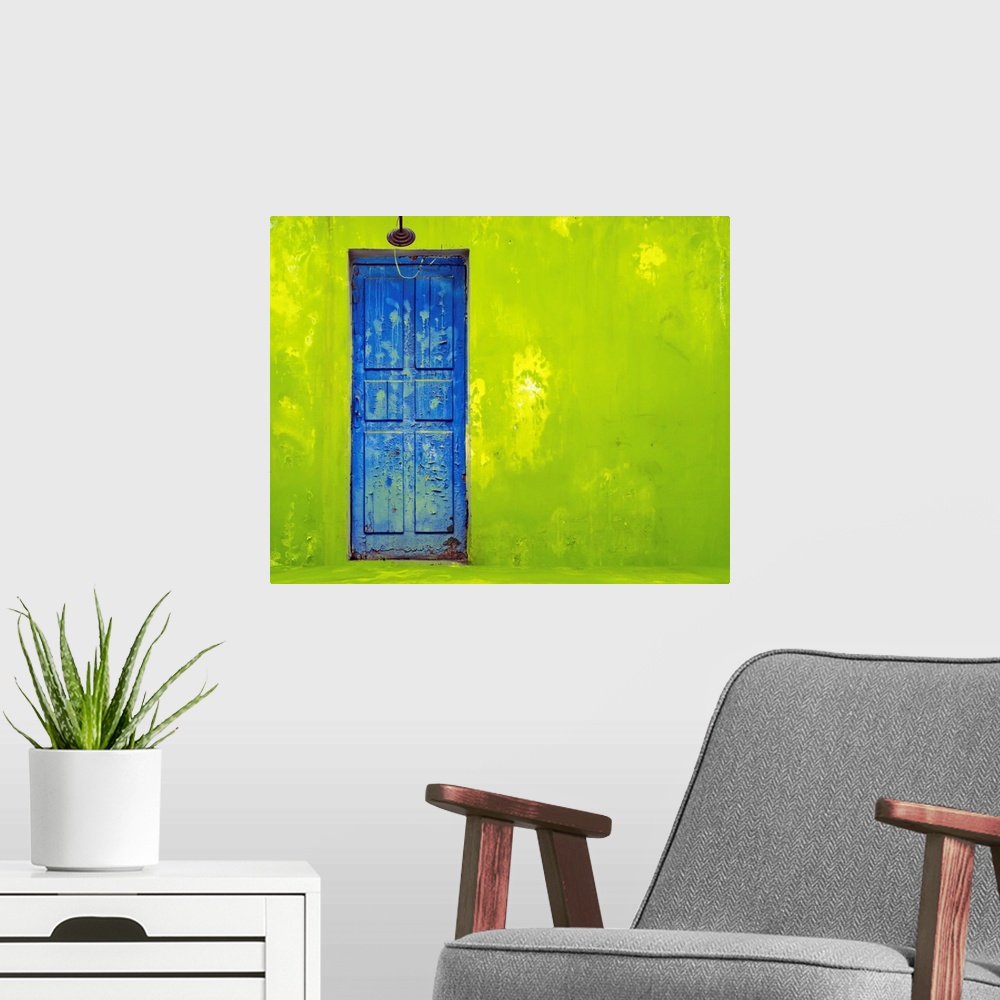 A modern room featuring Blue Door In A Shabby Green Wall