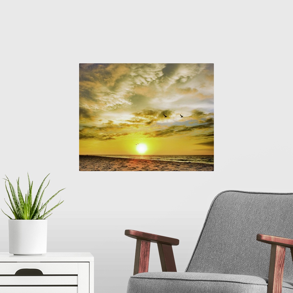 A modern room featuring A beautiful Destin Beach Sunrise with orange and white clouds.