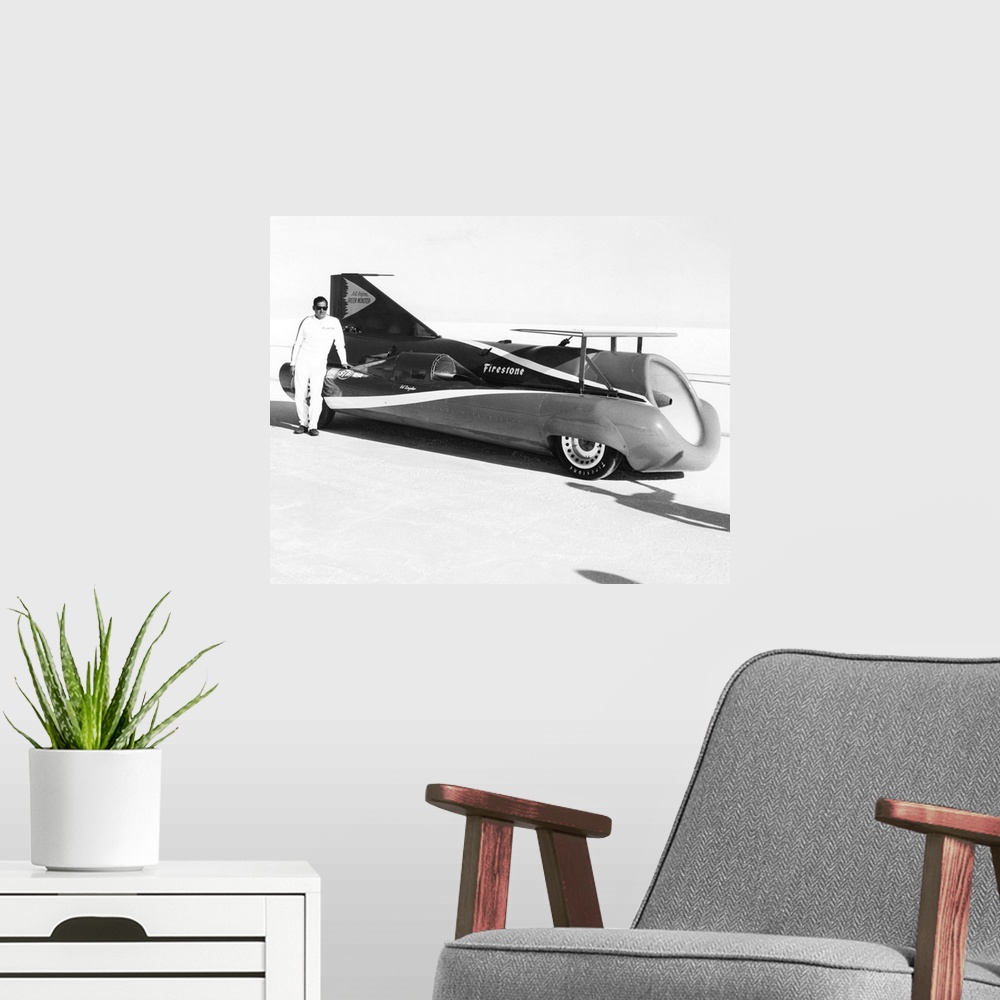 A modern room featuring Art Arfons on the Bonneville Salt Flats with his 'Green Monster' jet car. He would set three worl...