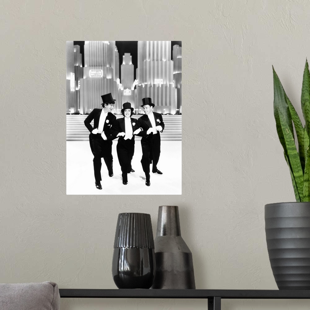 A modern room featuring Broadway Melody Of 1938, From Left: Buddy Ebsen, Eleanor Powell, George Murphy, 1937