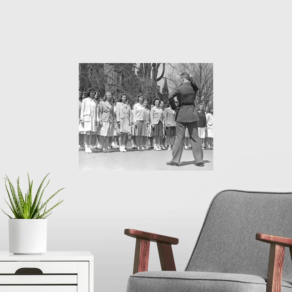 A modern room featuring Drill Instructor looks over new arrivals to Marine Corps Women's Reserve Officer's Candidate Scho...