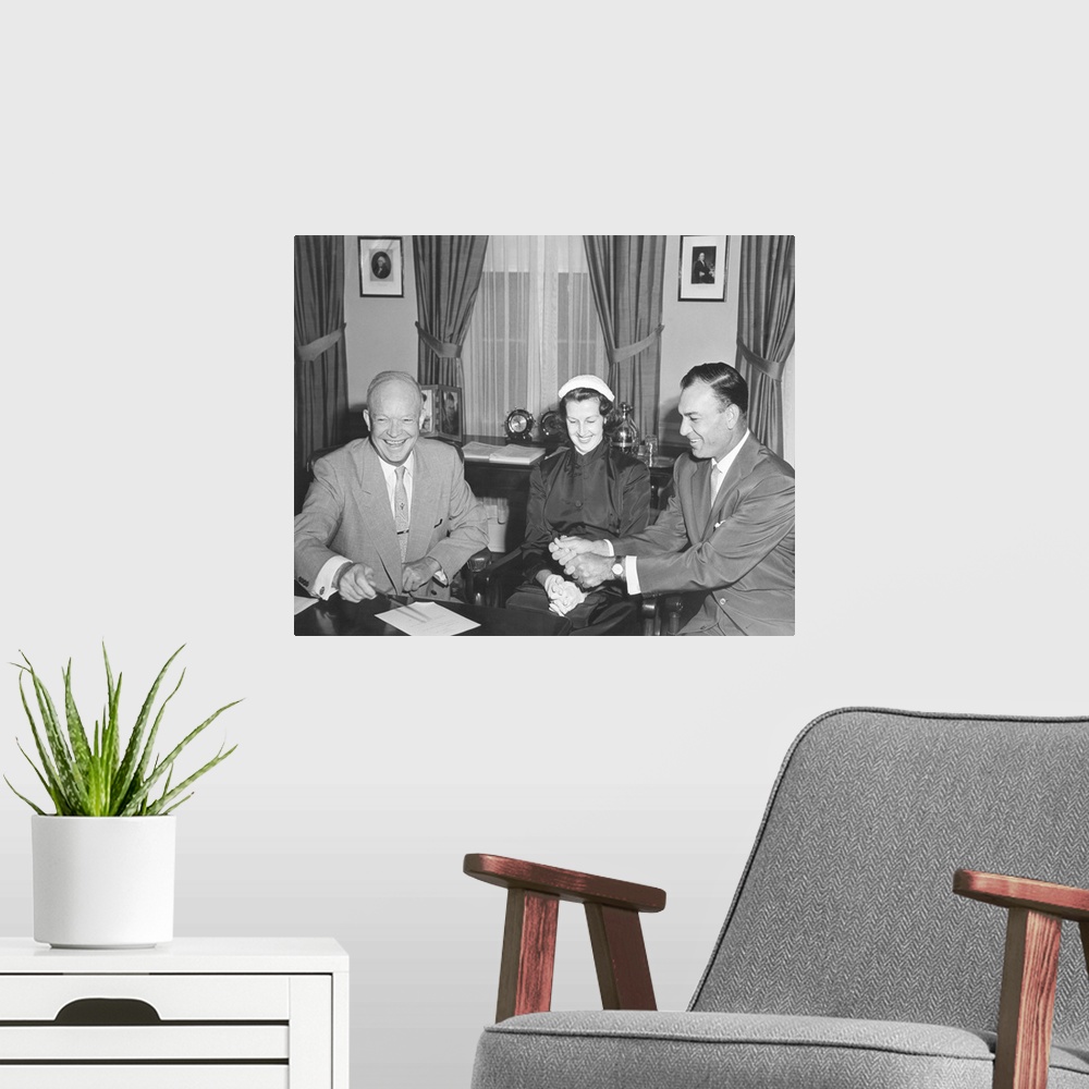 A modern room featuring President Eisenhower with Champion Golfer Ben Hogan and his wife in the Oval Office. Aug. 8, 1953