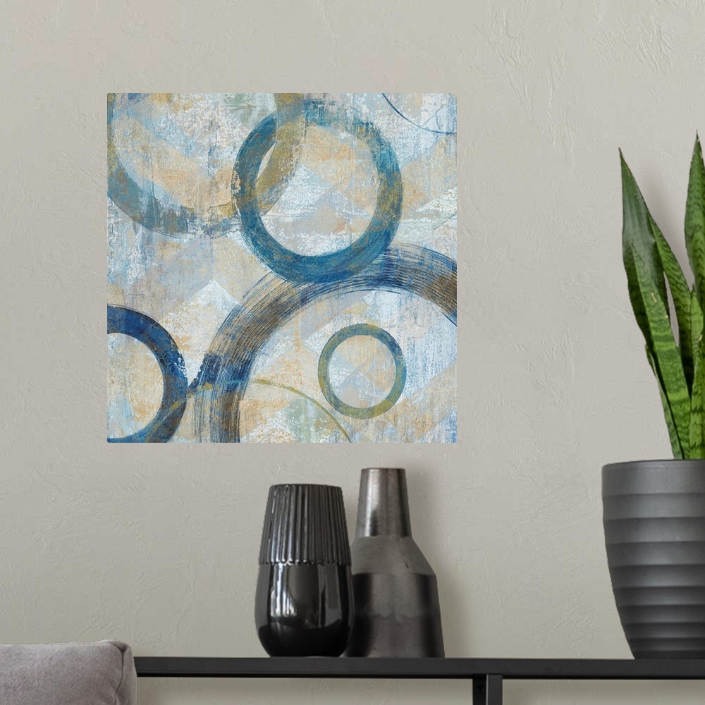 A modern room featuring Abstract painting that has big blue circular outlines with hints of gold on a textured background.