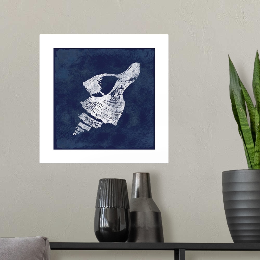 A modern room featuring Square cyanotype of a white silhouetted seashell on an indigo background with a white boarder.