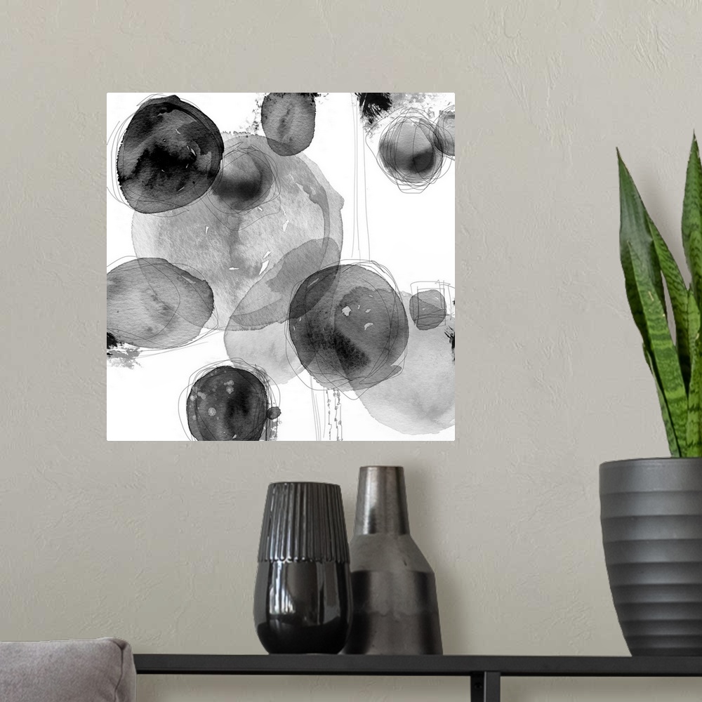 A modern room featuring Abstract watercolor painting of circular shapes in shades of grey.