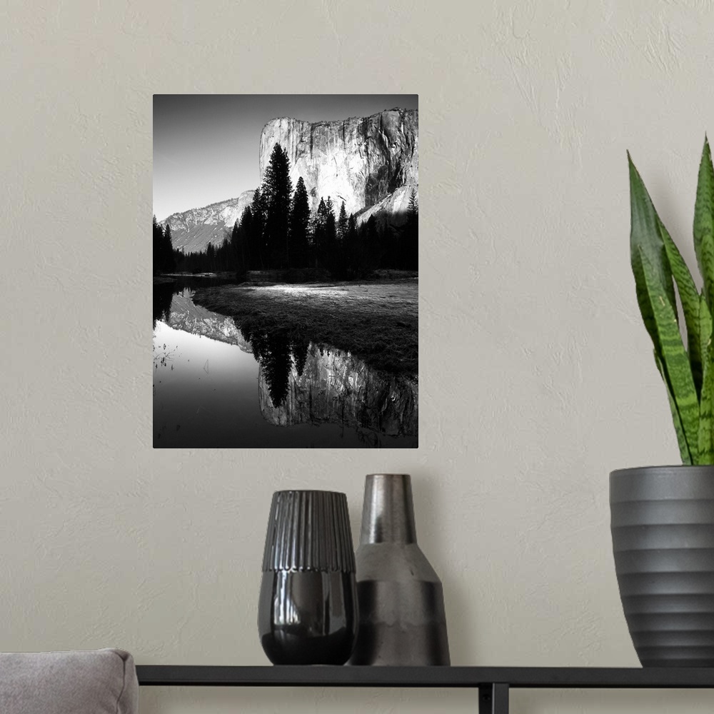 A modern room featuring Black and white photo of a cliffside behind dark trees in Yosemite.