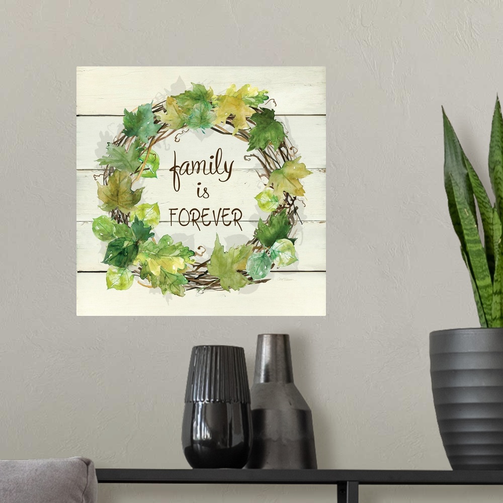 A modern room featuring A wreath of various leafs and branches surround the words, "Family is Forever".
