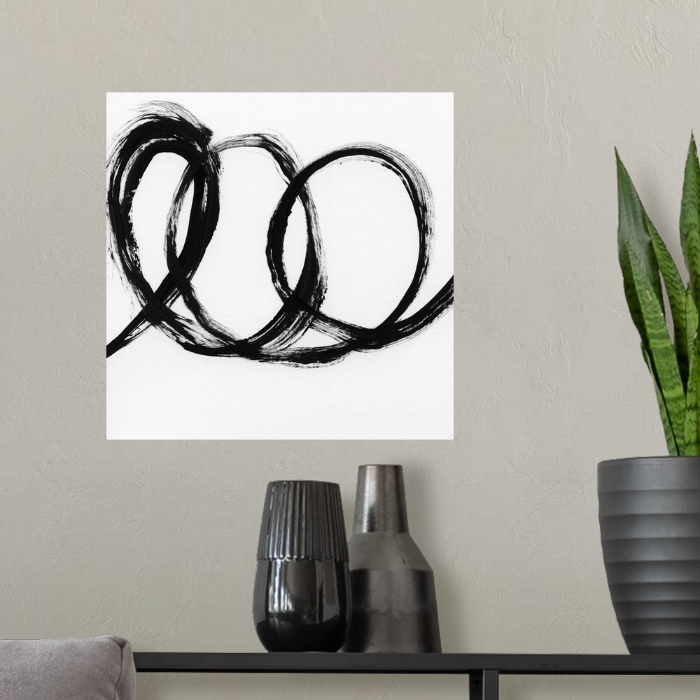 A modern room featuring Square black and white abstract painting with a thick, bold, loopy line.