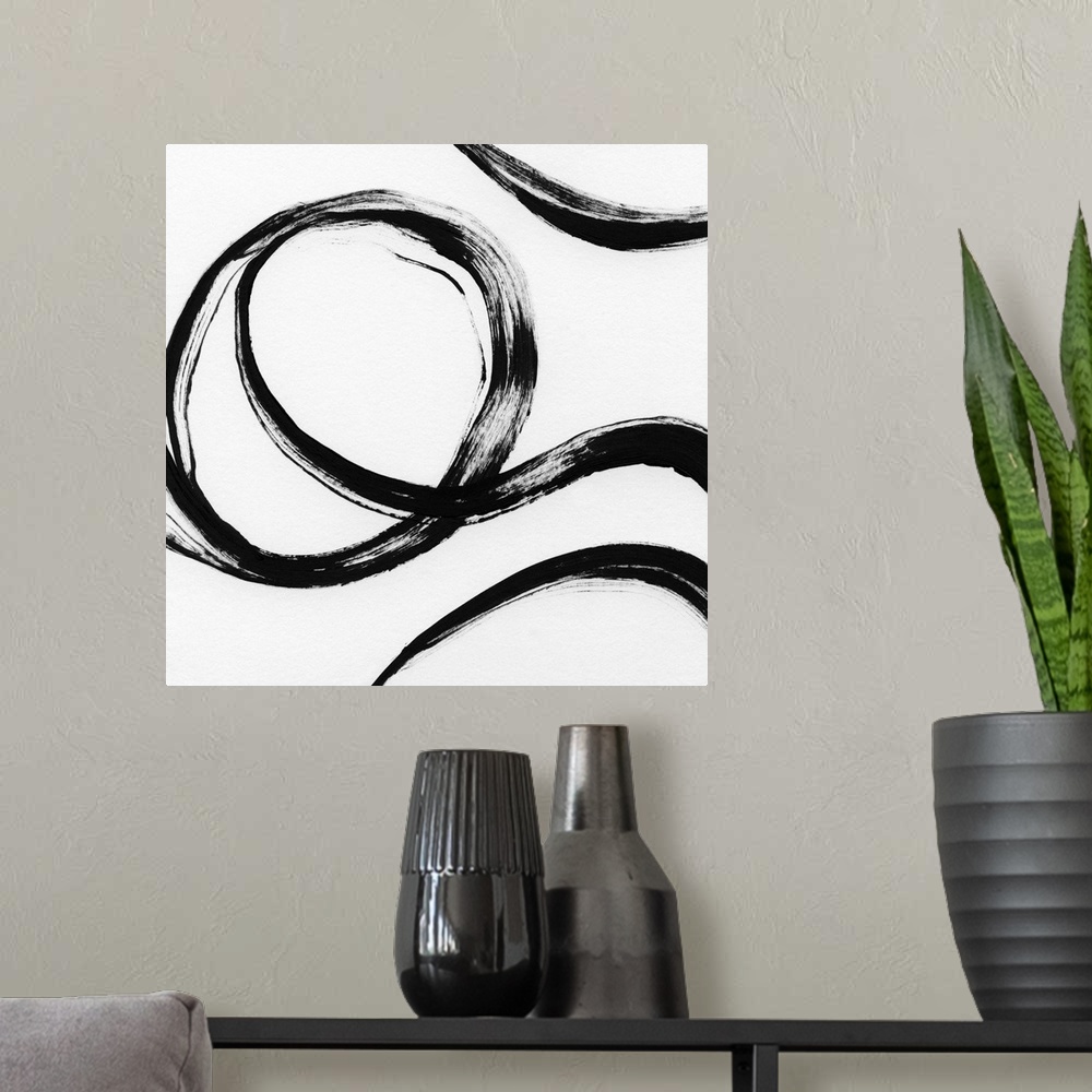 A modern room featuring Square black and white abstract painting with thick, bold, curvy lines.