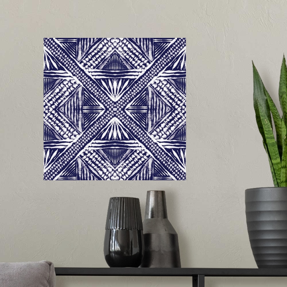 A modern room featuring Square abstract art in indigo and white hues with kaleidoscope-like patterns and designs.