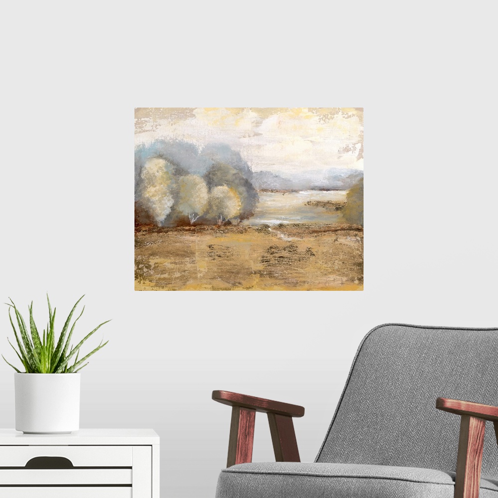 A modern room featuring Contemporary landscape painting of a golden field with soft trees at the edge and a pale yellow sky.