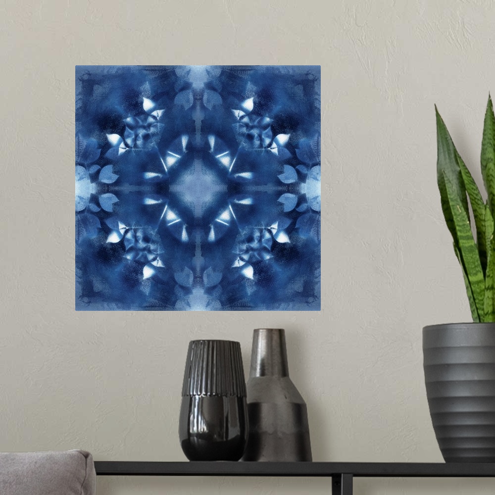 A modern room featuring Square abstract art in navy blue and white hues with kaleidoscope-like patterns and designs.