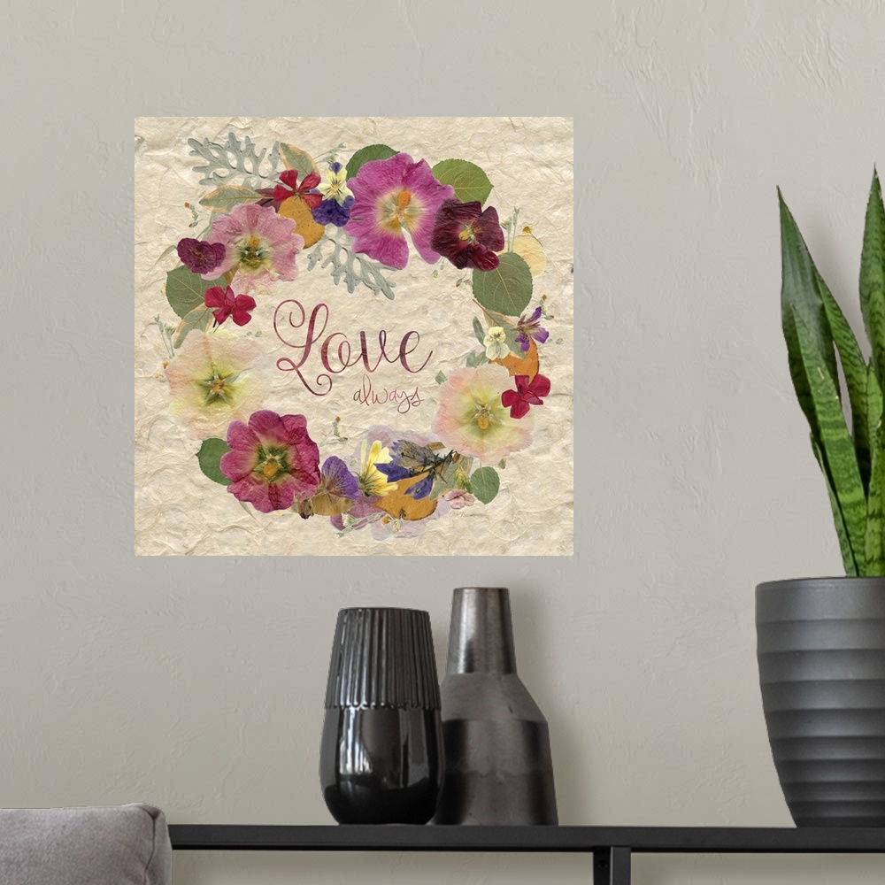 A modern room featuring The word "love" in a wreath made of dried, pressed flowers.