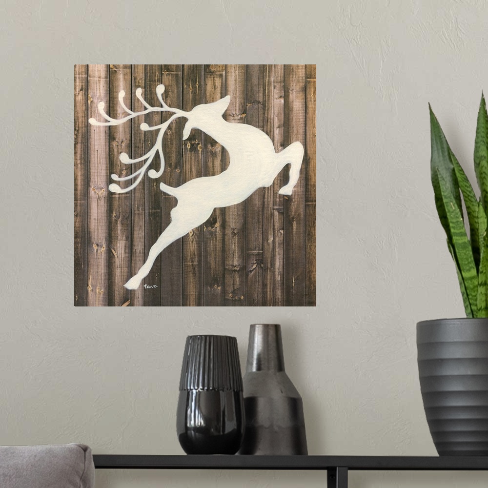 A modern room featuring A decorative painting of a white reindeer silhouette on a wood background.