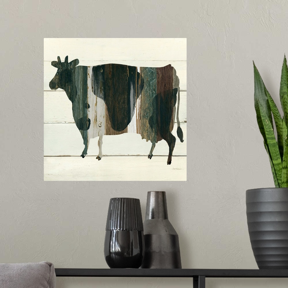 A modern room featuring A painting of a cow using multicolored stained wood placed on a white wooden background.