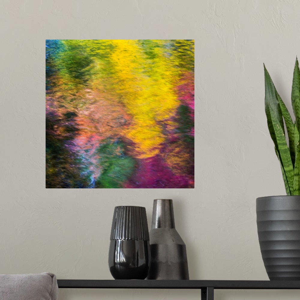 A modern room featuring Reflections of a colorful forest in rippling water, creating an abstract image.