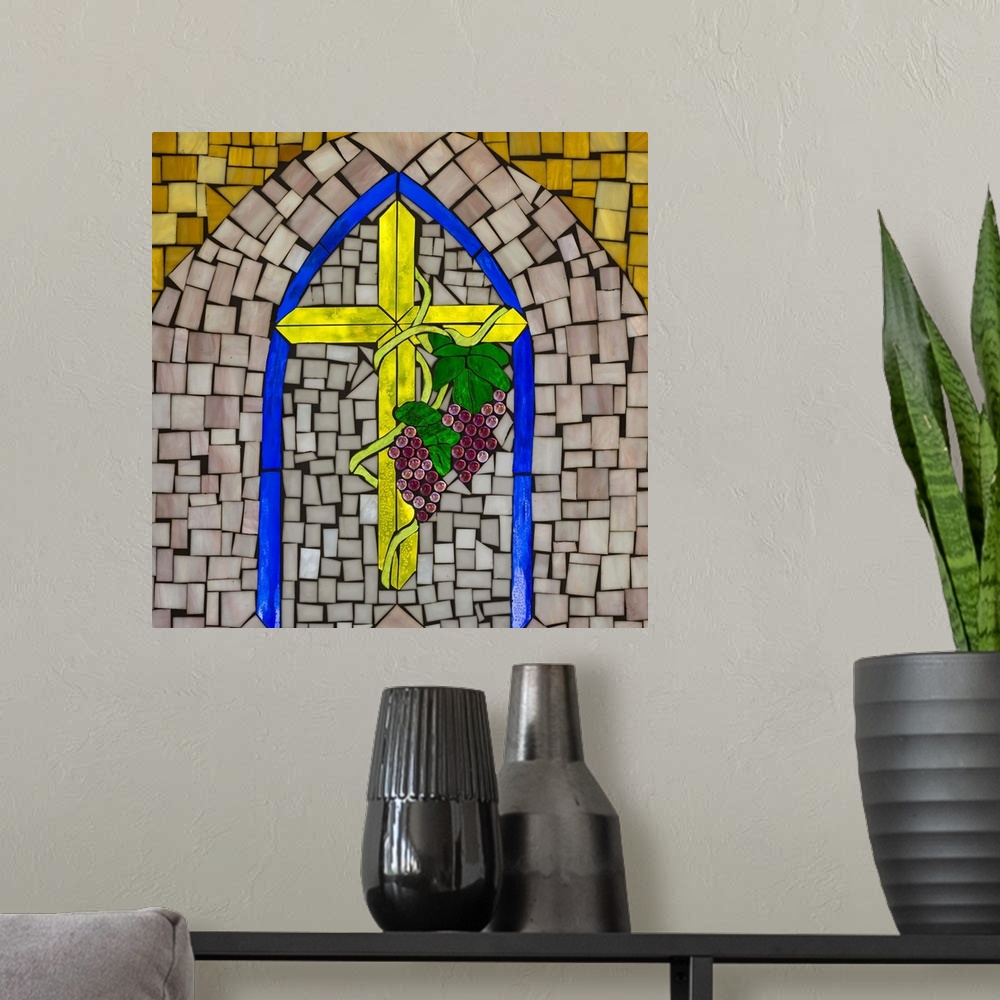 A modern room featuring Artwork done in a stained-glass style depicting a cross and wine grapes, symbols of Christianity.