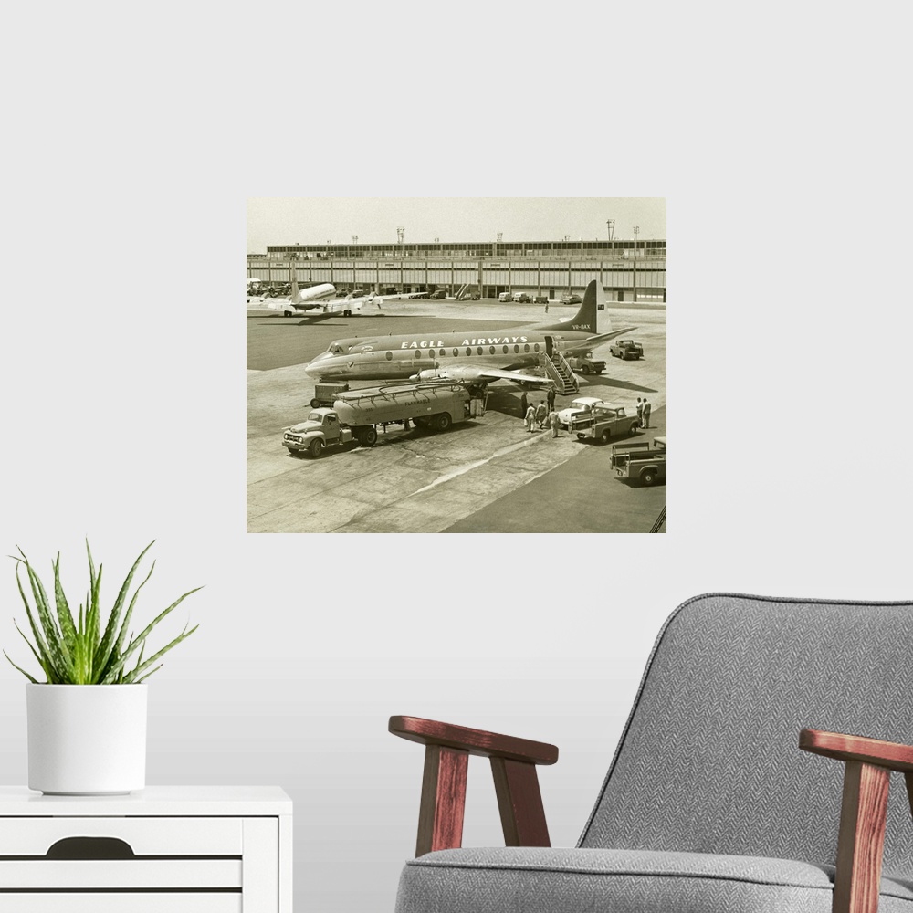 A modern room featuring Airplane getting refuelled on airport runway, (B&W), (Elevated view)