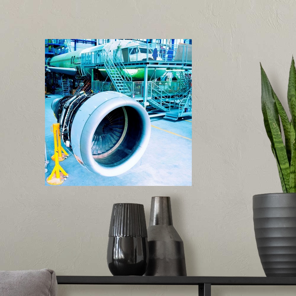 A modern room featuring An aircraft engine and aircraft body in a hanger