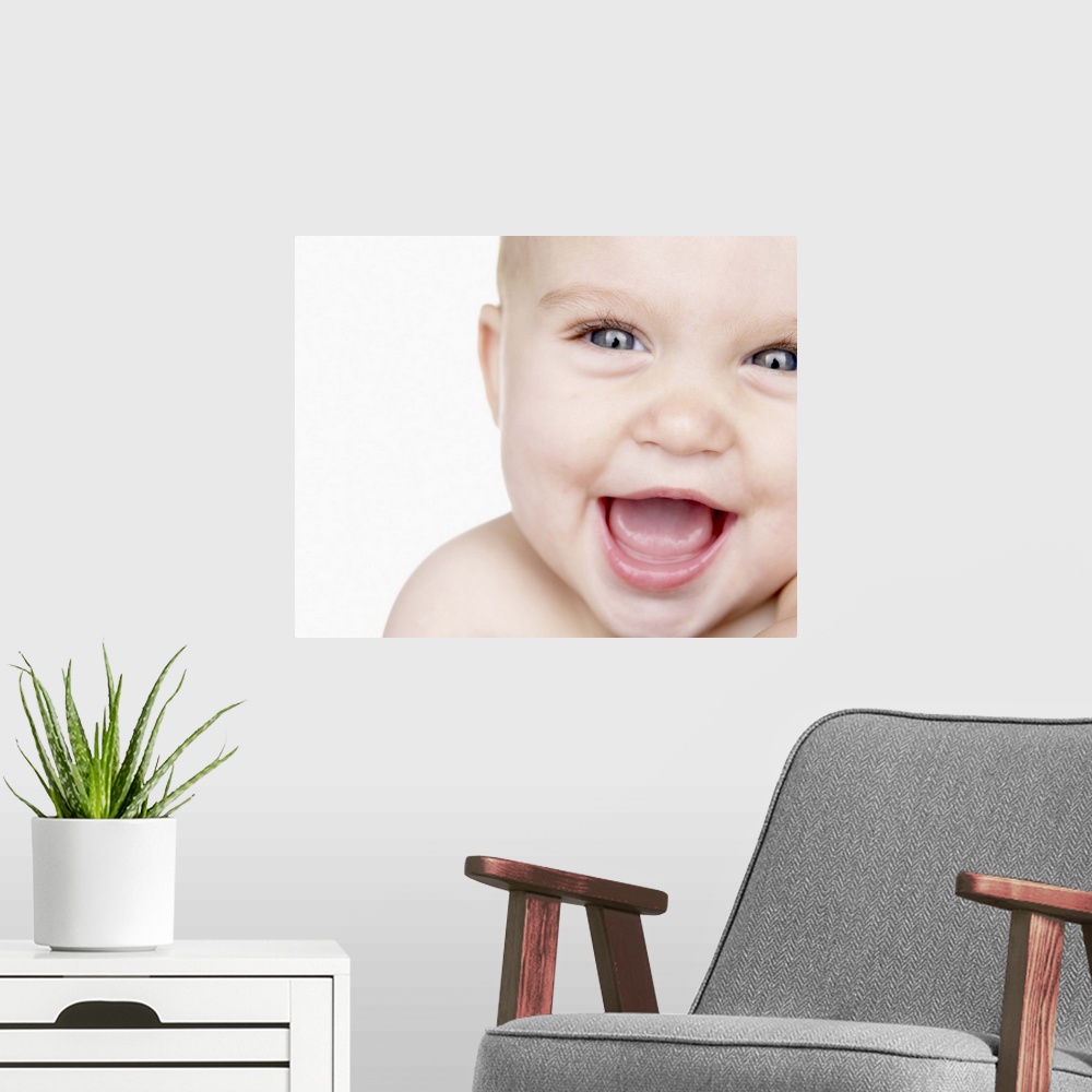 A modern room featuring Baby boy (6-9 months) laughing, close up, portrait, studio shot