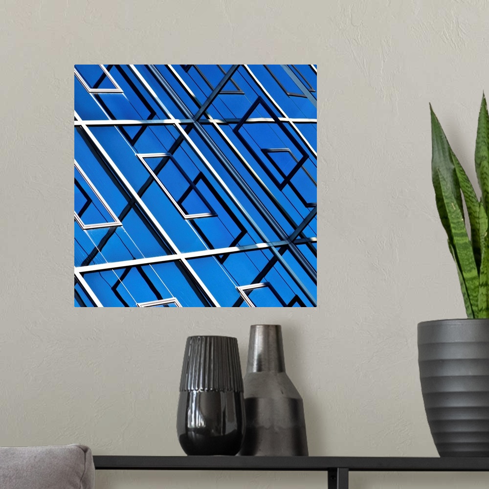 A modern room featuring Blue, abstract and geometric reflection on  facade of modern building.