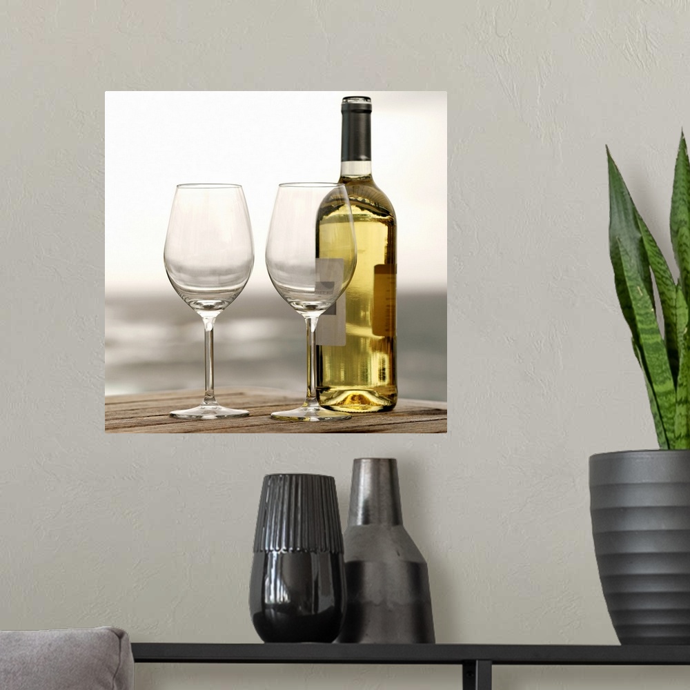 A modern room featuring Square photograph on a large canvas of two empty wine glasses sitting on a wooden table, along wi...
