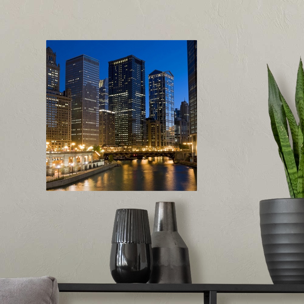 A modern room featuring Wall docor of Chicago buildings lit up with a bridge running across the river.