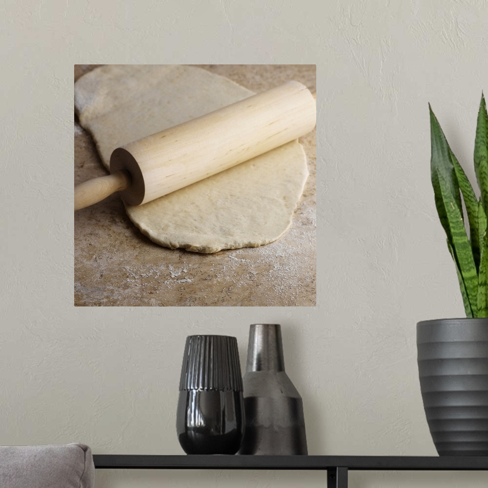 A modern room featuring Dough and rolling pin on countertop