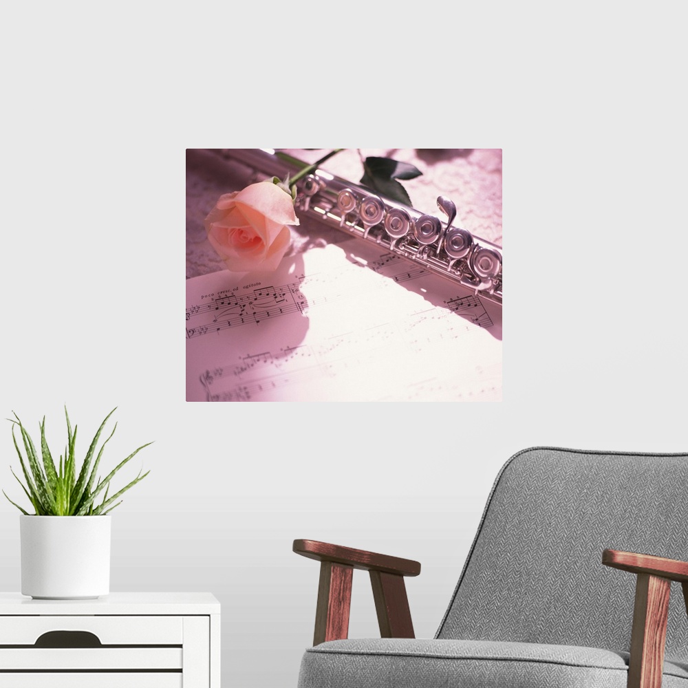 A modern room featuring Flute next to sheet music and pink rose