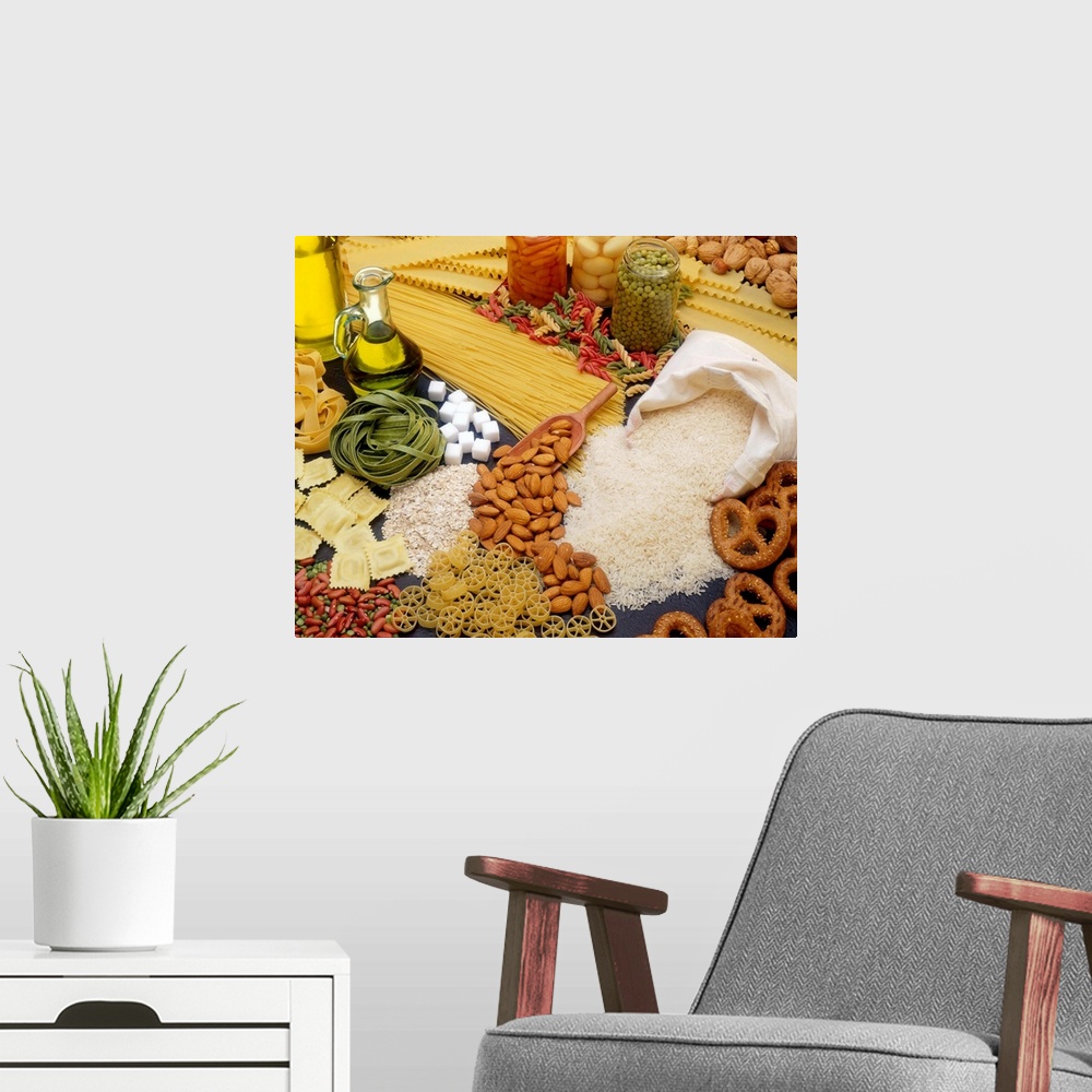 A modern room featuring All different types of pasta, nuts and beans are scattered about on a flat surface.