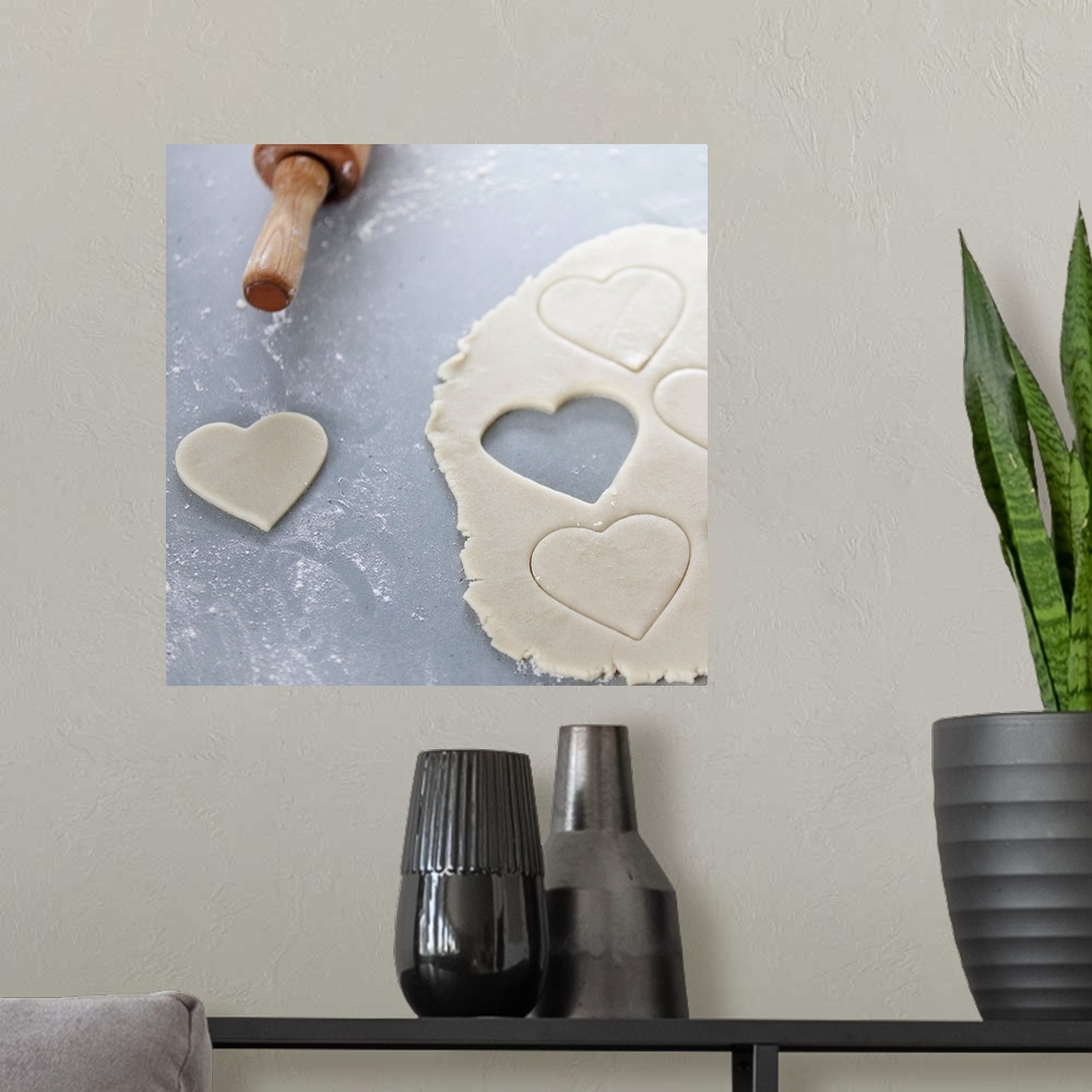 A modern room featuring Heart shape cut out of a sheet of rolled out cookie dough