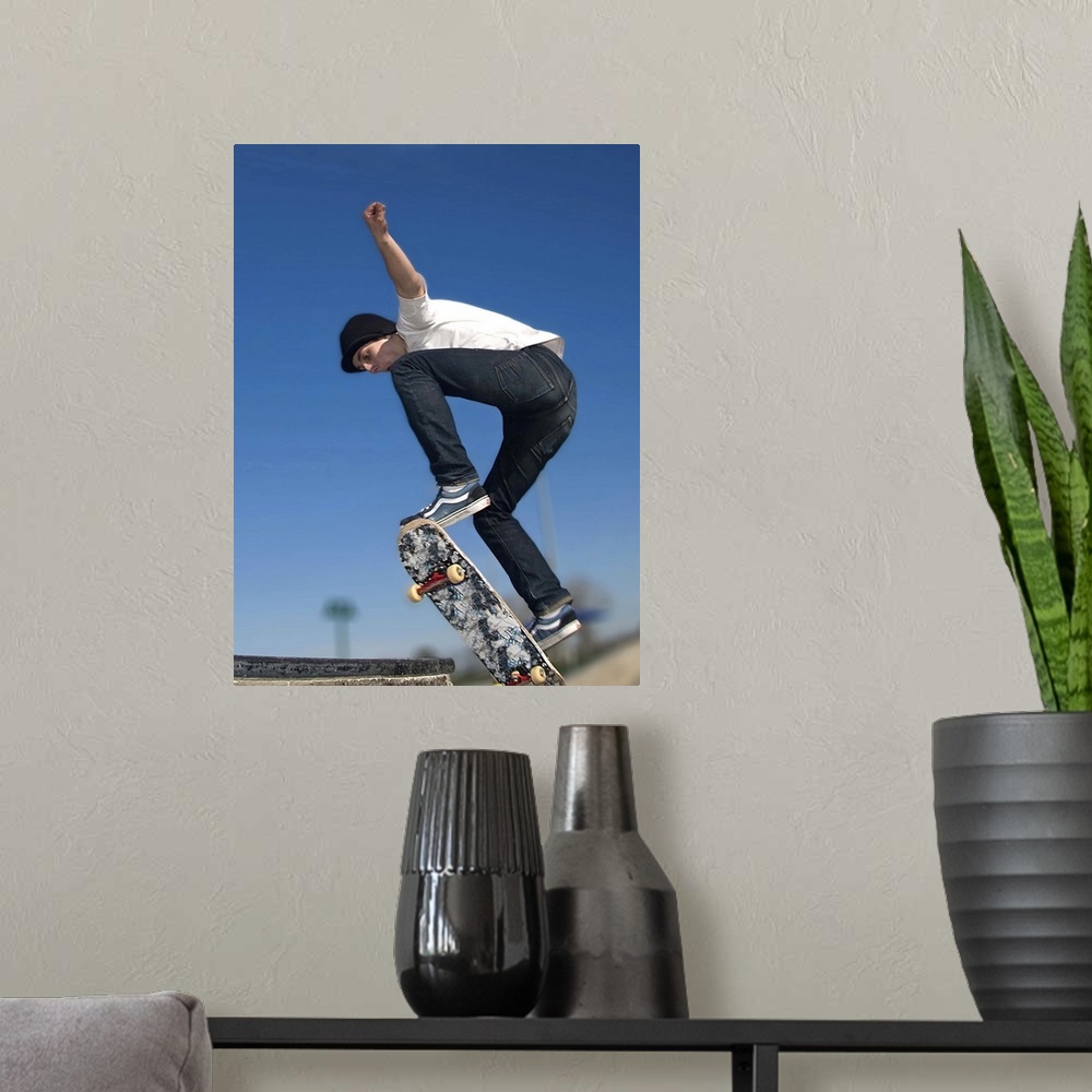 A modern room featuring Not his name but a stunt he is doing called an Ollie.... jumping that board up about 2' onto a cu...