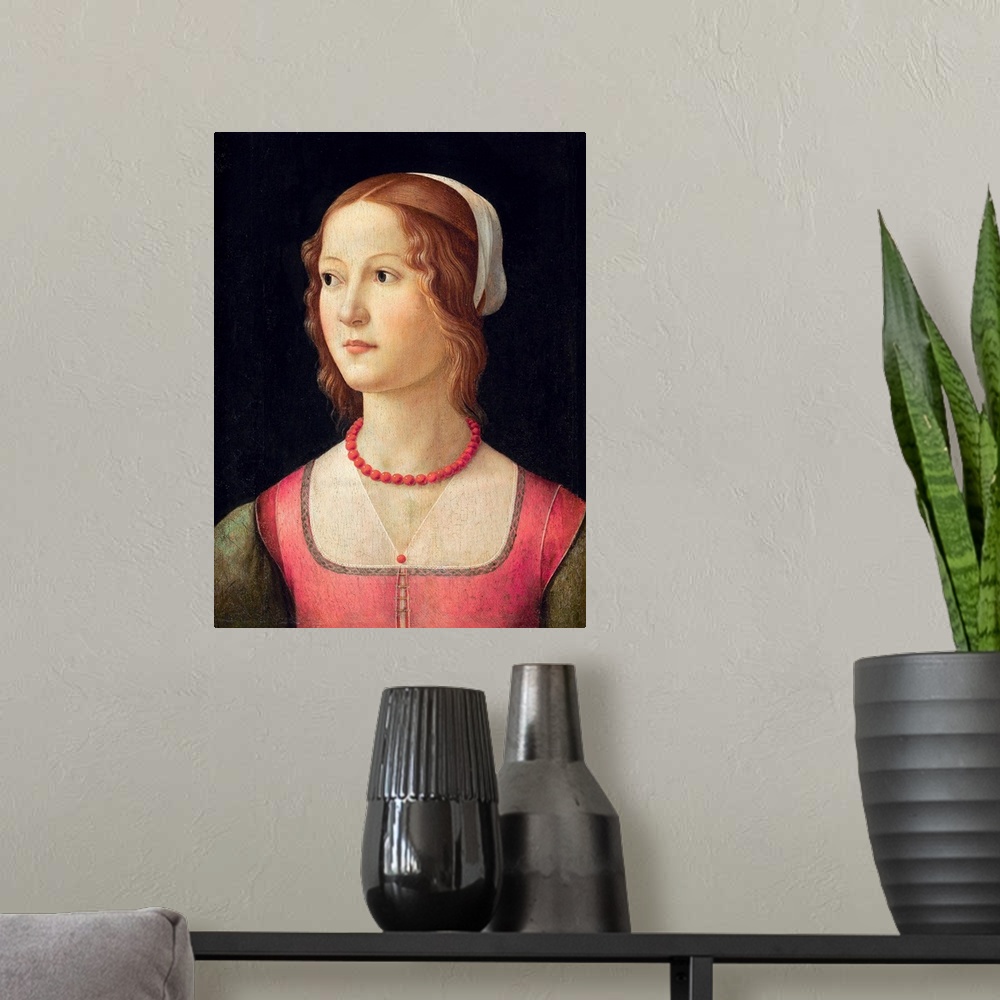 A modern room featuring Portrait of a young woman wearing a coral bead necklace. Circa 1485. Tempera on panel. 44 x 32 cm...