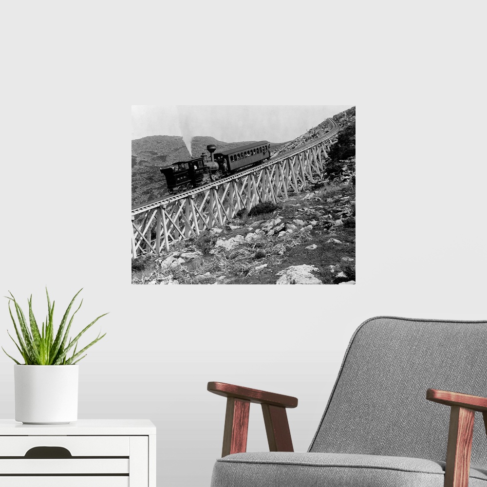 A modern room featuring A locomotive pushes a passenger car up Jacob's Ladder, a steep railroad bridge on Mount Washingto...