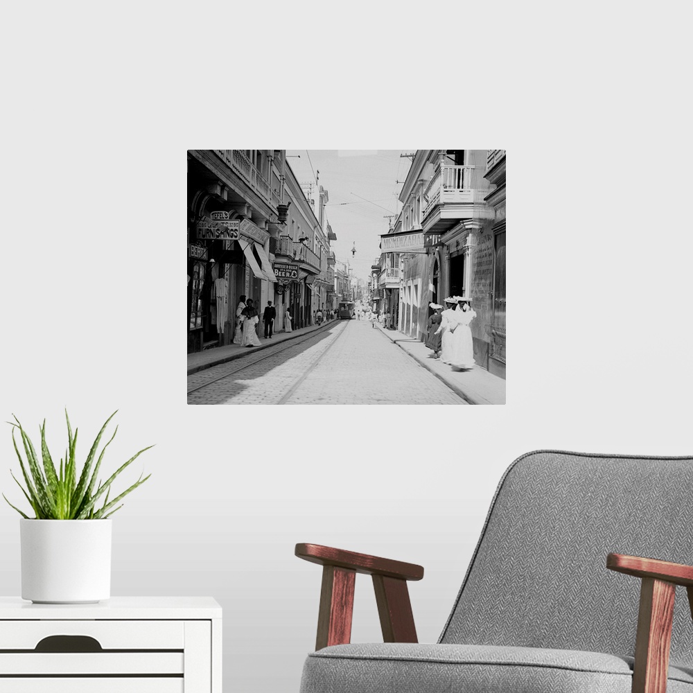 A modern room featuring The old narrow colonial San Francisco Street in San Juan, with tracks and a street car running on...