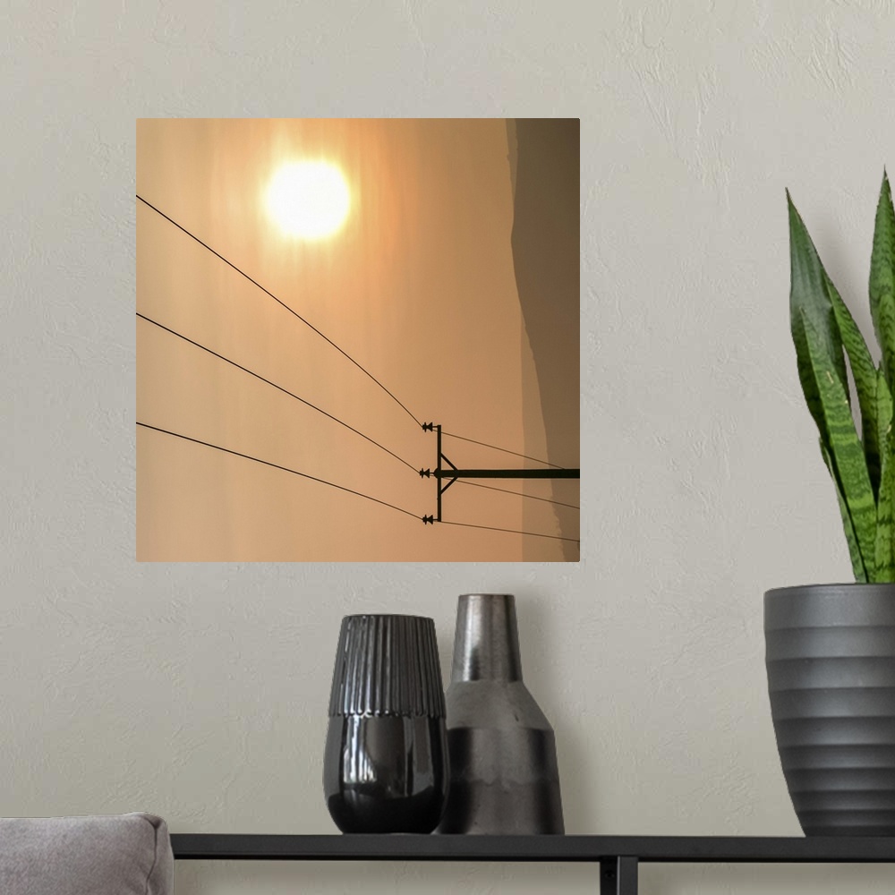 A modern room featuring Telephone wires and pole with sunset in background.