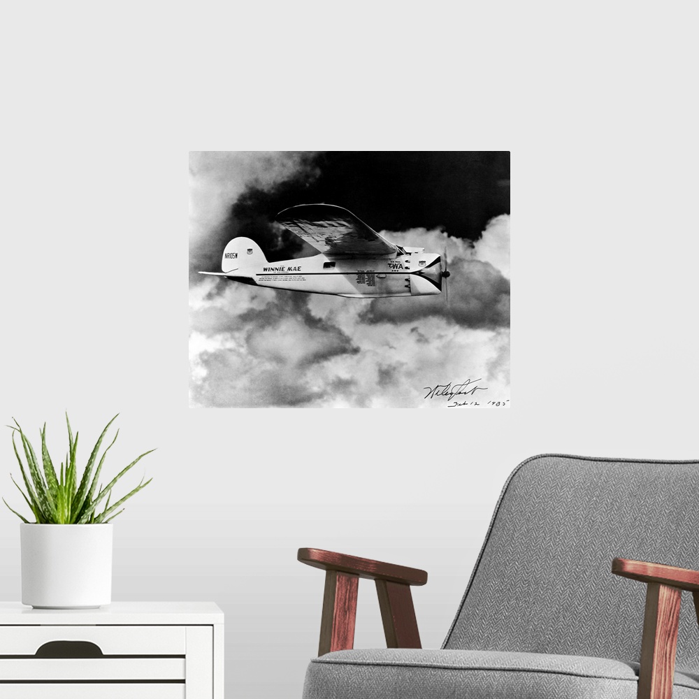 A modern room featuring The Winnie Mae of Oklahoma flies through cloudy skies.