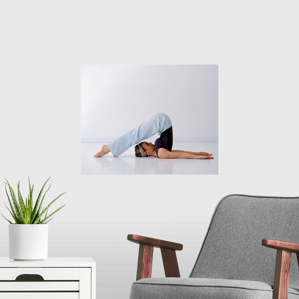A modern room featuring Woman in a yoga position
