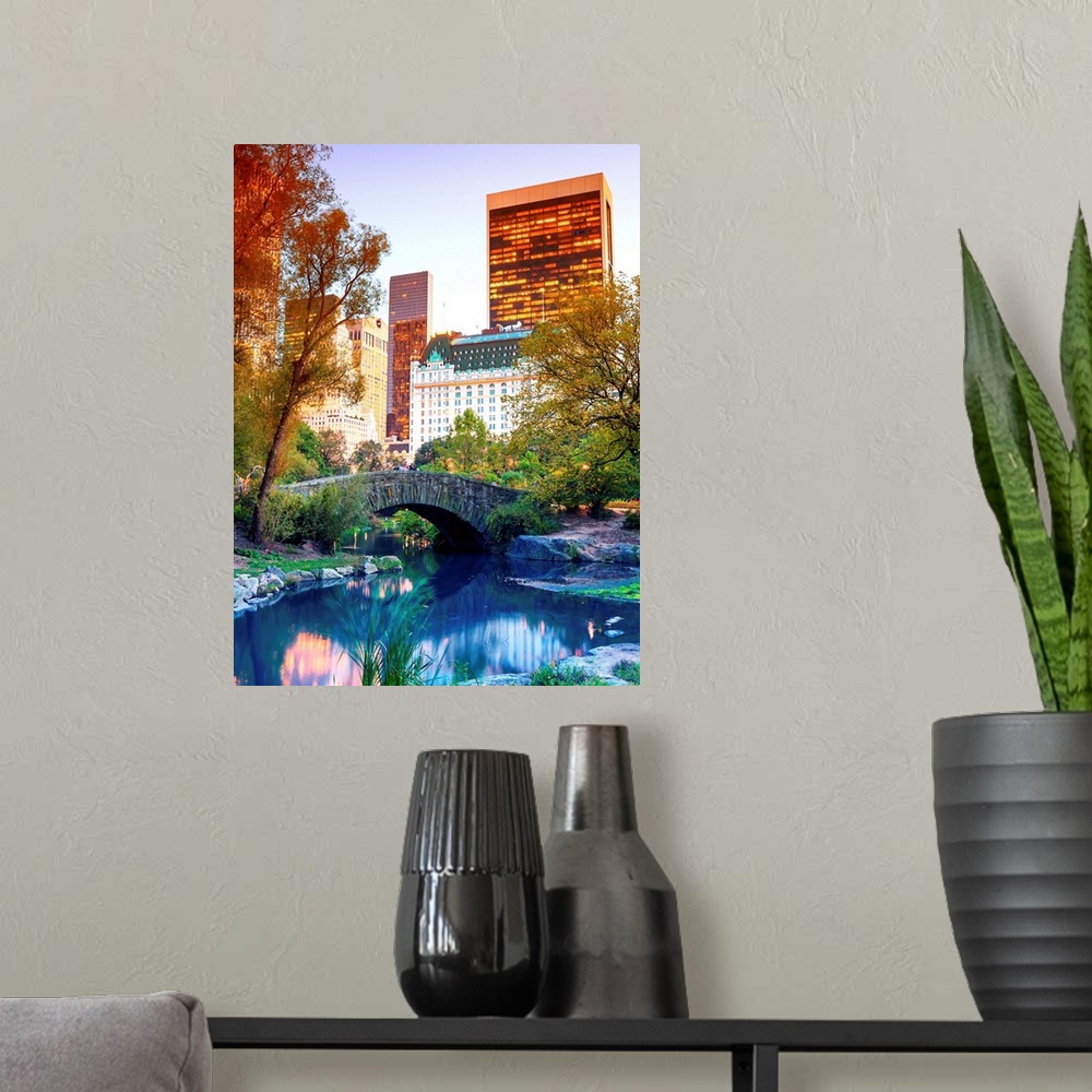 A modern room featuring Vividly colored photograph of a bridge over a stream in Central Park, with skyscrapers in the dis...