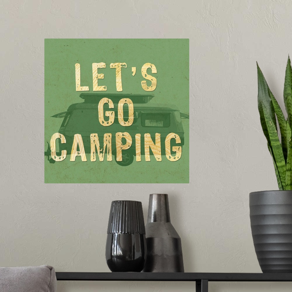 A modern room featuring A green-toned image of a recreational trailer with the words "Let's go camping."