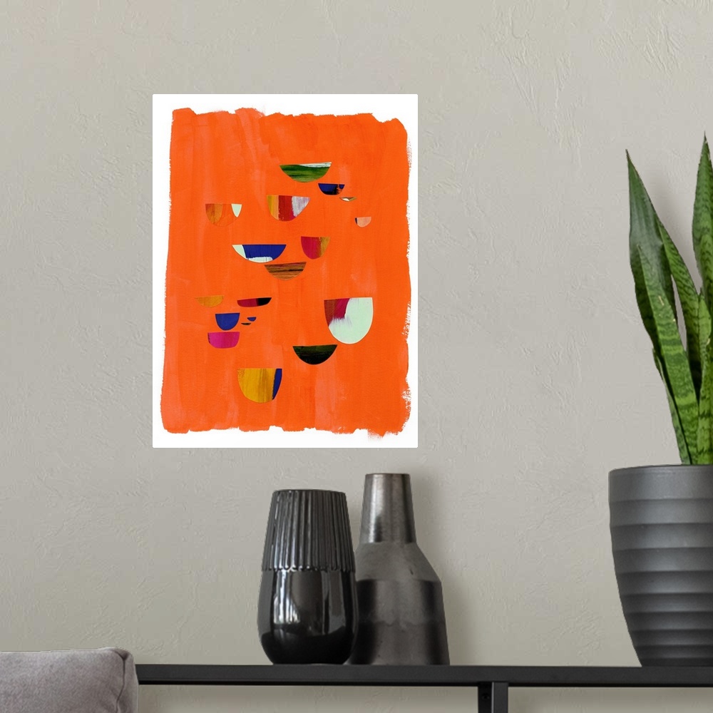 A modern room featuring Mod abstract art with red and blue shapes on orange.