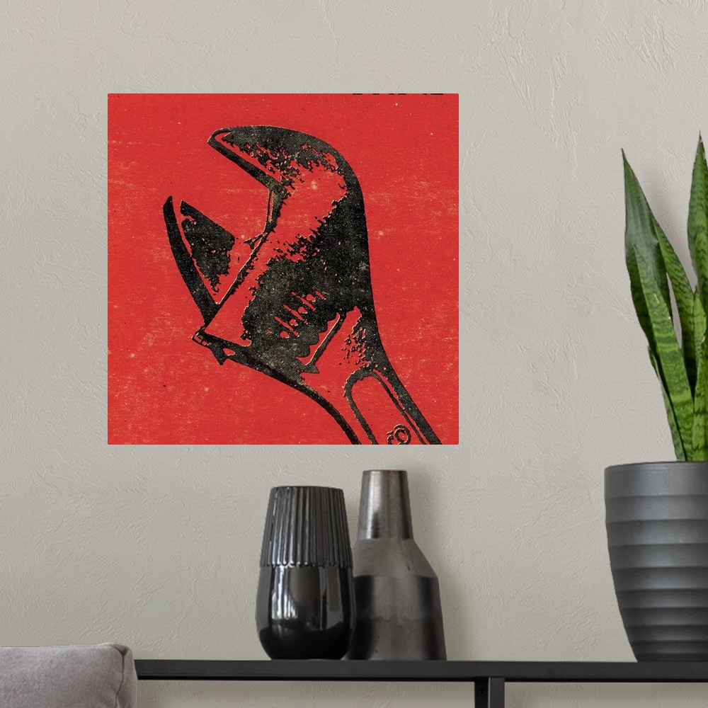 A modern room featuring Square art of a wrench on a red background.