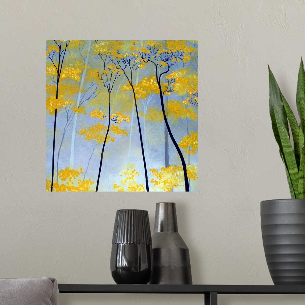 A modern room featuring Square painting of golden tree tops.