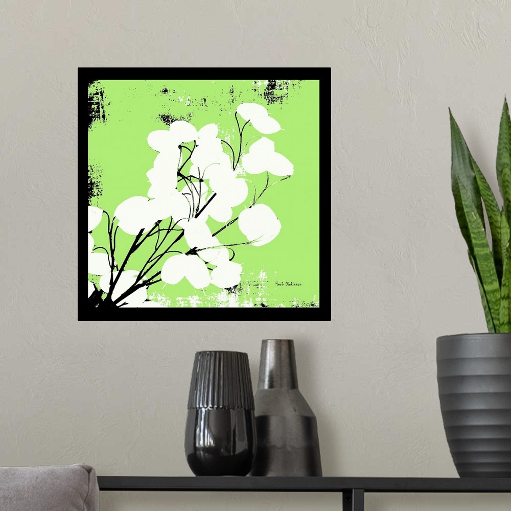 A modern room featuring Square silhouetted painting of a money plant in bright green, black, and white with a black boarder.
