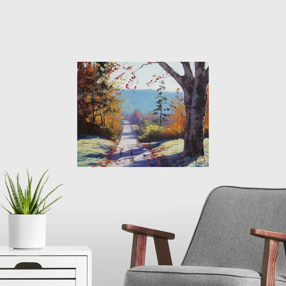 A modern room featuring Contemporary painting of an idyllic countryside landscape, with a road cutting through autumn fol...