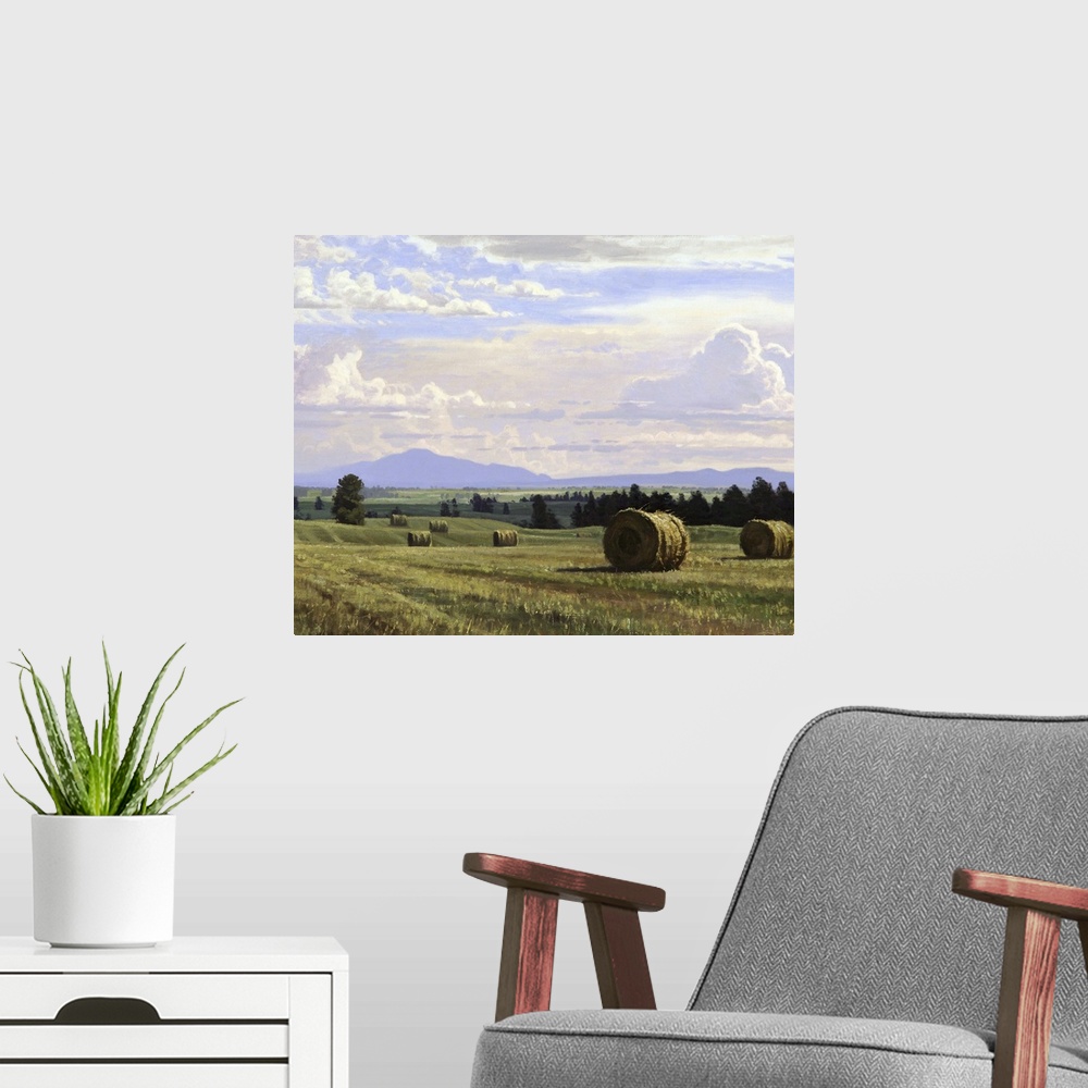 A modern room featuring A contemporary landscape painting of freshly cut hay bails sitting in a countryside field.