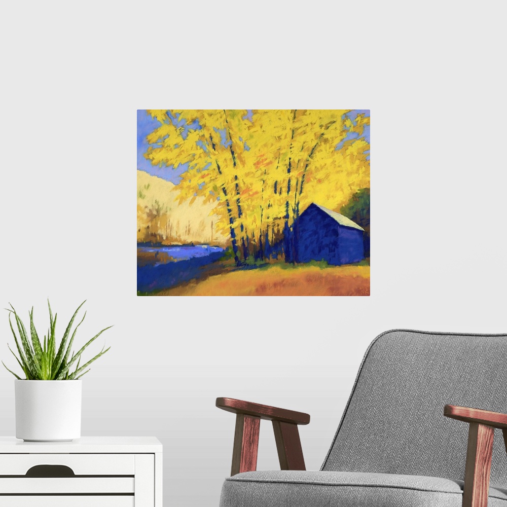 A modern room featuring A contemporary painting of a building and trees with yellow leaves.