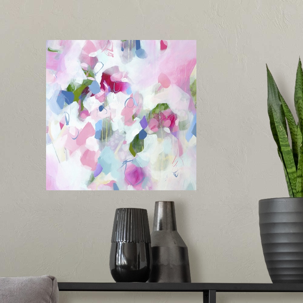 A modern room featuring Abstract artwork in cheerful shades of pink, white, and blue.