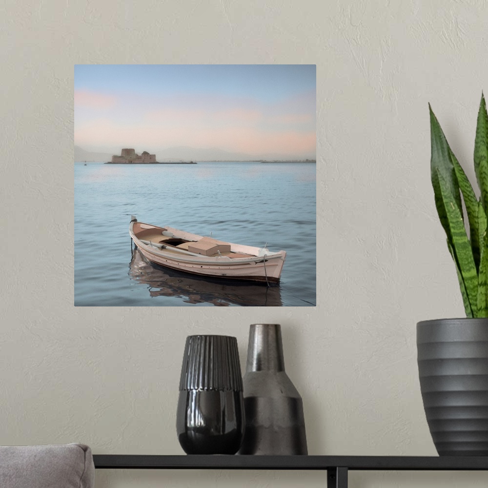 A modern room featuring A single boat floating in the calm waters of the Mediterranean with a nearby castle in the backgr...